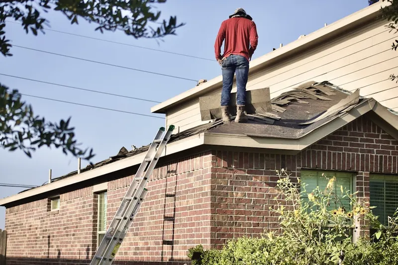 Professional roofer working on a residential roof in Pellettown